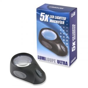 The lumiloupe magnifier outside of the box which is to the right