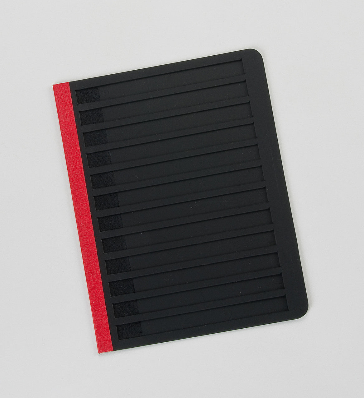 A black letter guide with a black background and red tape on the side for hinged opening.